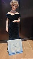 Full-height view of Princess Diana porcelain figurine beside certificate