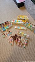 Group shot of dolls, crib bases, nursery shelf