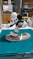 Side view of resin Mickey Mouse figurine on base