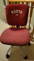 Front view of chair showing ROOTS 73 logo, seat and back fabric