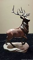 Front three-quarter view of elk figurine on base