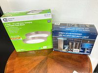 Both retail boxes side by side showing product fronts