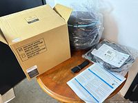 Opened box with pump components, strap, manual visible