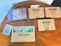 All five eXtremeRate kits on table: three sealed LED kit boxes, one window box, one purple shell kit case