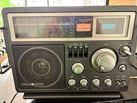 Front view showing speaker, tuning scales, controls and powered digital readout