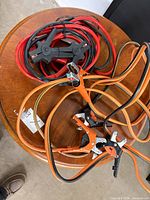 Both jumper cable sets coiled on table