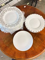 Stack of plates showing three pattern types on round wooden table