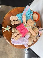 Top view of five dolls on round table