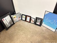 All seven frames lined up on floor against wall