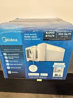 Factory-sealed box front showing Midea branding and 8,000 BTU rating