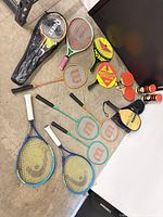 Overall view of all racquets, paddles and tennis ball cans