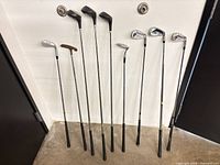 Lineup of nine golf clubs showing club types and shaft condition