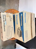 Panasonic and Suprocky boxed ventilation units on table