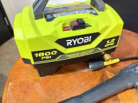 Front view of Ryobi 1800 PSI pressure washer showing branding and PSI/GPM specs