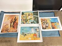 All four loose prints laid out on moving blanket showing imagery and margins