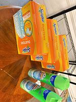 Full lot view: three Swiffer boxes and two Scrubbing Bubbles cans