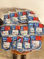 All 15 sealed Tripp Lite cables arranged on table