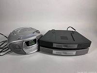 Philips portable CD player and two stacked Bose multi-CD changers