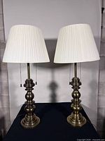 Full view of both brass lamps with shades