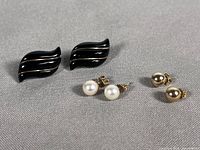 All three pairs of earrings: black onyx marquise studs, cultured pearl studs, gold ball studs