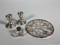 Group shot of two Birks candle holders, glass trivet and perfume bottle