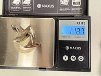 Cufflinks on scale showing 11.87 g total weight