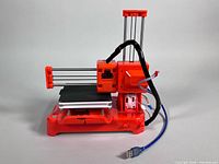 Front left view of EasyThreed K7 printer with USB cable