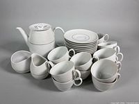 full set grouped showing coffee pot, creamer, sugar, cups, saucers