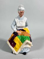 Front view of Royal Doulton Eventide figurine showing woman with quilt