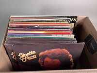 Box of approximately 36 opened vinyl albums with spines showing assorted titles