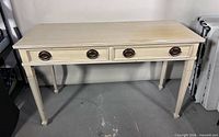 Front view of console table showing two drawers and four metal ring pulls