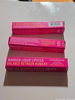 Three boxed Cheekbone Beauty Warrior Liquid Lipsticks stacked