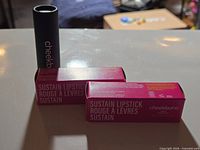 Two boxed Sustain Lipsticks and one unboxed tube