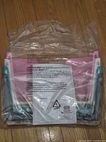 Sealed package showing stack of four file holders with warning label