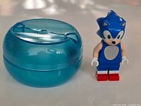 Minifigure standing beside speed sphere shell