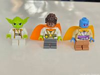 Group shot of three Lego Star Wars minifigures Yoda, Kai Brightstar, Lys Solay