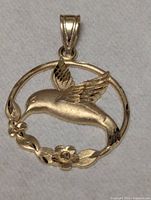 Full view of gold hummingbird pendant front