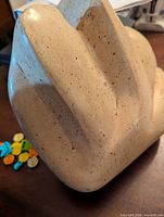 front-angled view showing limestone texture and shape