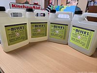 Front view of four unopened Mrs. Meyer's Clean Day hand soap refill jugs