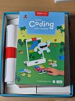 Open packaging showing Osmo Coding with Awbie box and stand
