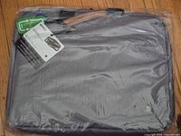 Front of grey PKG messenger bag sealed in plastic with tags