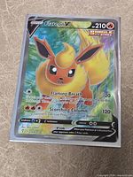 Front view of sleeved Flareon V full art card showing holographic foil and details