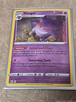 Full front view of sleeved Gengar holo card showing card text, number and condition