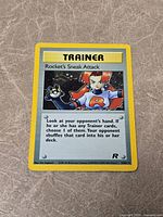 Front of Rocket's Sneak Attack holo card showing artwork, text and foil pattern