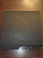 Top view of black PlayStation 3 Slim console