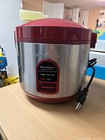 Front view showing control panel, stainless body, red lid