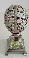 Front view of closed floral enamel egg on stand