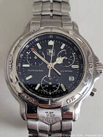 Front close-up showing dial, bezel, subdials, missing crown