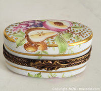 Closed Limoges oval trinket box showing front fruit design and clasp