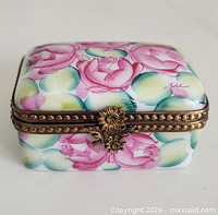 Front view showing hand-painted floral design, brass hinge and clasp